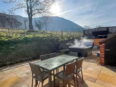 a table and chairs and a grill with a table and chairs at Uk46557 - Caradoc in Church Stretton