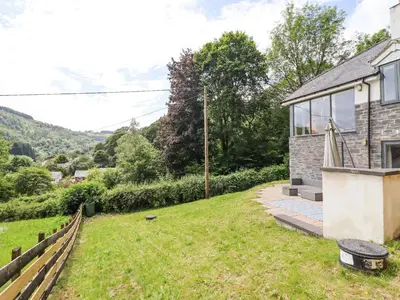 a stone house with a view of the countryside at Bryn Golau in Llangollen