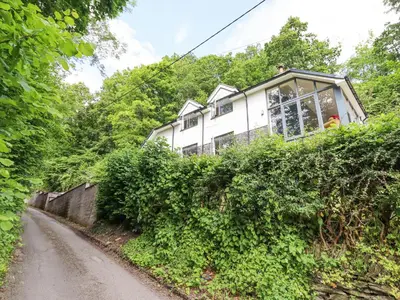 a house on top of a hill with a road at Bryn Golau in Llangollen