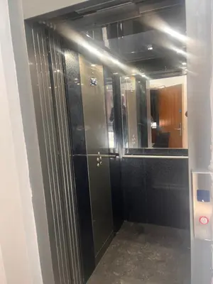 a bathroom with a door and a mirror at Tumbledown Hotel in Shrewsbury