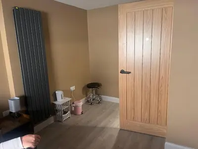 a room with a wooden door and a wooden floor at Tumbledown Hotel in Shrewsbury
