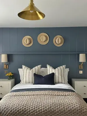 a bedroom with a bed with a blue wall at Tobias Apartment, 2 Bedroom, Aberaeron in Aberaeron