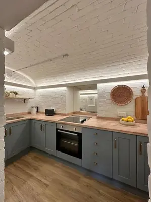 a kitchen with gray cabinets and a counter top at Tobias Apartment, 2 Bedroom, Aberaeron in Aberaeron
