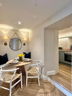 a kitchen and dining room with a table and chairs at Tobias Apartment, 2 Bedroom, Aberaeron in Aberaeron