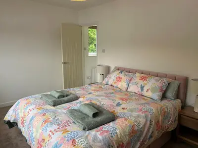a bedroom with a bed with two towels on it at Kimberly House in Arthog