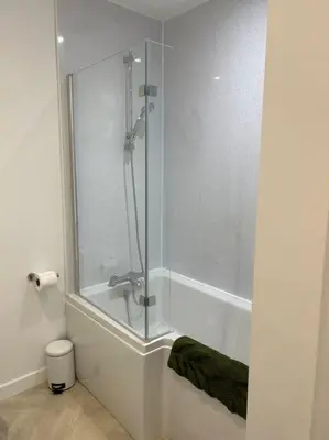 a shower with a glass door in a bathroom at Kimberly House in Arthog