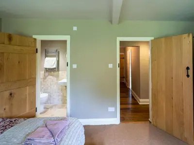 a bedroom with a bed and a bathroom at The Old Chapel Charming countryside retreat - Pass the Keys in Ludlow