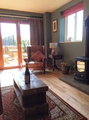a living room with a couch and a fireplace at A Tranquil Retreat for Two in Pont-Robert