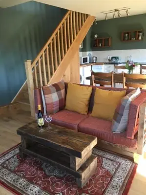 a living room with a couch and a table at A Tranquil Retreat for Two in Pont-Robert