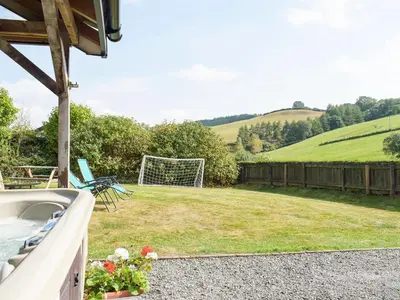 a backyard with a soccer field and a goal at Heyope Cottage in Llangunllo