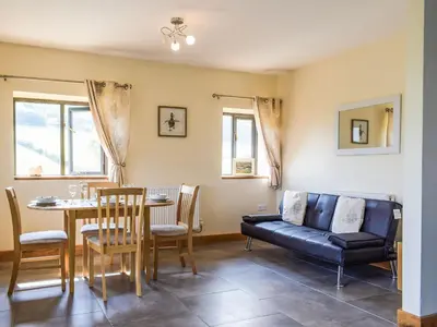 a living room with a couch and a table at Heyope Cottage in Llangunllo