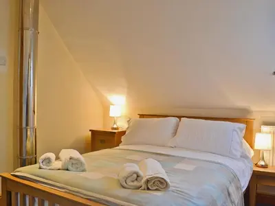 a bedroom with a bed with towels on it at Celyn in Montgomery