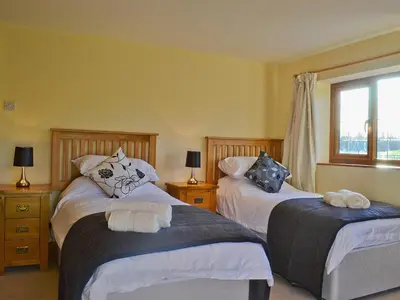 a bedroom with two beds and a window at Celyn in Montgomery