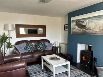 a living room with a couch and a fire place at The Rope and Anchor Aberaeron in Aberaeron