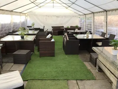 a restaurant with tables and chairs in a tent at Dolphin Inn in Llanymynech