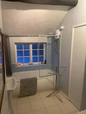 a bathroom with a tub and a sink and a window at Dolphin Inn in Llanymynech