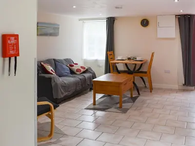 a living room with a couch and a table at The Dairy - Uk47471 in Llanerch-Aeron