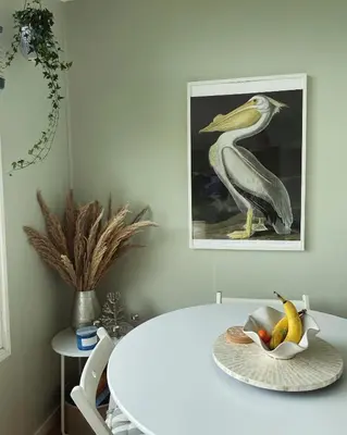 a bird sitting on a table with a bowl of fruit at Cosy private Chalet in Tywyn