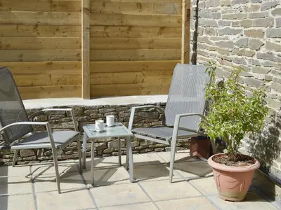 two chairs and a table on a patio at The Granary - Or3 in Henfynyw Upper