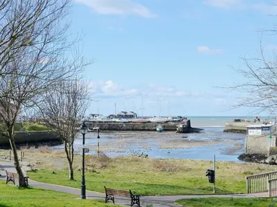 a marina with a bunch of boats in the water at The Granary - Or3 in Henfynyw Upper
