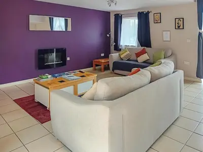 a living room with a couch and a table at The Coach House - Or4 in Henfynyw Upper