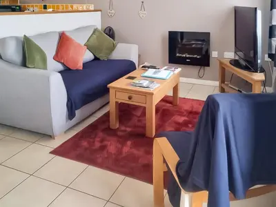 a living room with a couch and a coffee table at The Cow Shed - Or5 in Henfynyw Upper