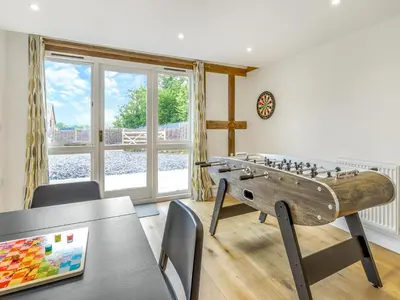 a living room with a table and a foosball table sidx sidx at Orchard Barns - Uk47200 in Stapleton