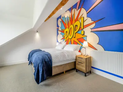 a bedroom with a bed with a painting on the wall at Orchard Barns - Uk47200 in Stapleton