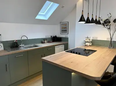 a kitchen with a wooden counter top and a sink at Penny Red apartment in Kington in Kington