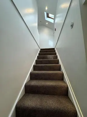 a staircase in a house with brown carpet at Penny Red apartment in Kington in Kington