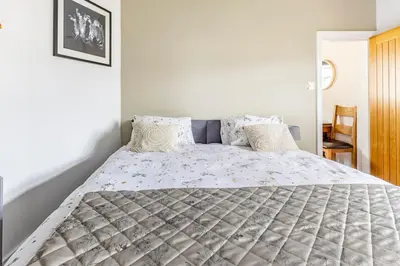 a bedroom with a large bed with pillows at Castell Bach in Llangollen