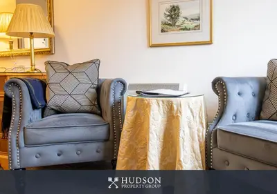 two chairs and a table in a living room at 2 Bed Shrewsbury Apartment in Great Location in Shrewsbury