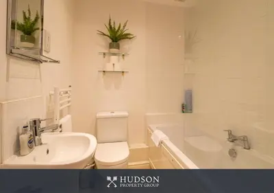 a bathroom with a sink and a toilet and a tub at Shrewsbury Apartment in Prime Location in Shrewsbury