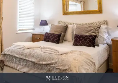 a bedroom with a bed with a mirror on the wall at Shrewsbury Apartment in Prime Location in Shrewsbury