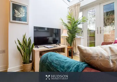 a living room with a tv and some plants at Shrewsbury Apartment in Prime Location in Shrewsbury