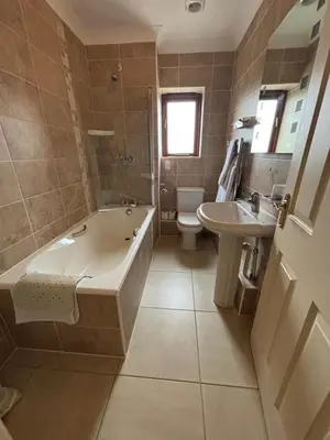 a bathroom with a tub and a toilet and a sink at Albright Hussey Manor in Shrewsbury