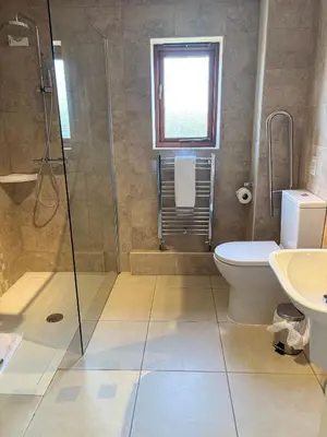 a bathroom with a shower and a toilet and a sink at Albright Hussey Manor in Shrewsbury