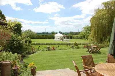 a garden with a gazebo and a lawn at Albright Hussey Manor in Shrewsbury
