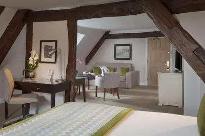 a bedroom with a bed and a desk and a table at Albrighton Hall Hotel and Spa, a member of Radisson Individuals in Shrewsbury