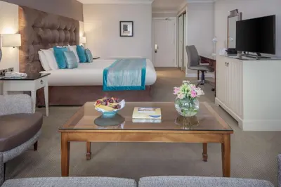 a hotel room with a bed and a coffee table at Albrighton Hall Hotel and Spa, a member of Radisson Individuals in Shrewsbury