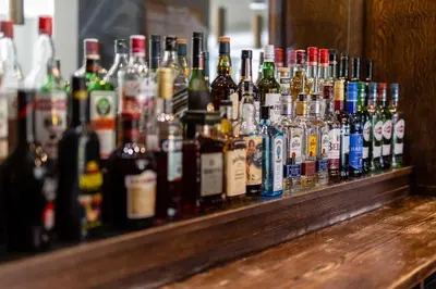 a bunch of bottles of alcohol sitting on a bar at Albrighton Hall Hotel and Spa, a member of Radisson Individuals in Shrewsbury