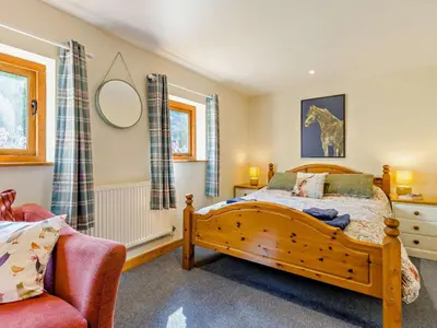 a bedroom with a wooden bed and a chair at 5 Bed in Craven Arms oc-95212 in Tugford