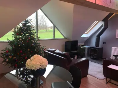 a living room with a christmas tree and a couch at The Coach House in Ludlow