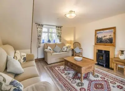 a living room with a couch and a table at Frondeg Bach in Tregaron