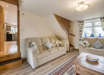 a living room with a couch and a table at Frondeg Bach in Tregaron