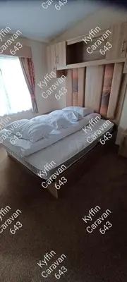 a bedroom with a bed with writing on the floor at Kyffin 643 in Barmouth