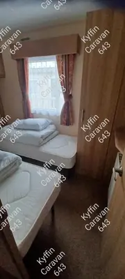 a room with two bunk beds with writing on the walls at Kyffin 643 in Barmouth