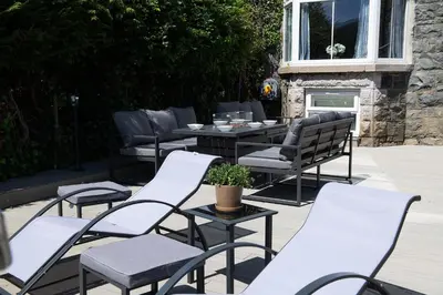 a group of chairs and tables on a patio at Eryri Snowdonia Premier Family Retreat with Hot Tub and Fire Pit in Dolgellau