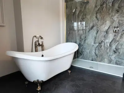 a white bath tub in a bathroom with a shower at The Castle Coaching Inn in Trecastle