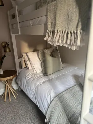 a bedroom with a bunk bed with a blanket at Posh Little Cottage in Llangollen